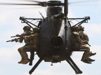 Rangers fly on Little Bird helicopter. USASOC photo (2018).