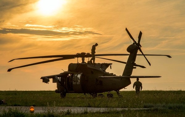 U.S. Soldiers assigned to the 2nd General Support Aviation Battalion, 4th Aviation Regiment, 4th Combat Aviation Brigade, 4th Infantry Division, conduct safety checks and prepare their UH-60 Blackhawk for air assault training at Mihail Koglniceanu Air Base, Romania, July 10, 2018. The Soldiers of 2nd GSAB are conducting similar training in multiple locations throughout Europe in support of Atlantic Resolve, a U.S. endeavor to fulfill NATO commitments by rotating U.S.-based units throughout the European theater to deter aggression against NATO allies and partners in Europe. (U.S. Army photo by Spc. Andrew McNeil / 22nd Mobile Public Affairs Detachment)