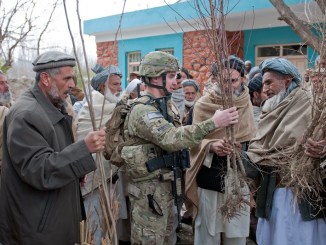 A member of an Agricultural Development Team (ADT) talks with an Afghan villager about crops. (Photo U.S. Army SPC Leslie Goble, 2012). Jeff Goodson article on development in conflict areas.
