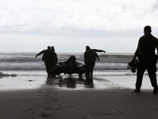 Marines with Hotel Company, 2nd Raider Battalion, Marine Corps Forces Special Operations Command (MARSOC) in Camp Lejeune, North Carolina, carry a Zodiac Rigid Hull Inflatable Boat into the surf at Onslow Beach on base, March 28, 2017. (Photo by Petty Officer 3rd Class Corinne Zilnicki, U.S Coast Guard).