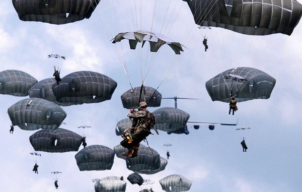 Paratroopers descending under canopy. (Photo source Fort Bragg, North Carolina, June 6, 2017)