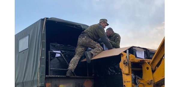 Ukrainian soldiers load IFAC first aid kits onto truck for transport to Ukrainian frontlines.